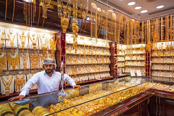 Jeweller displaying his wares at the Dubai Gold Souk