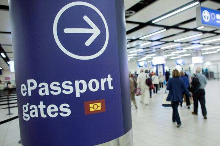 Passengers arriving at ePassport gate at passport control, Gatwick Airport